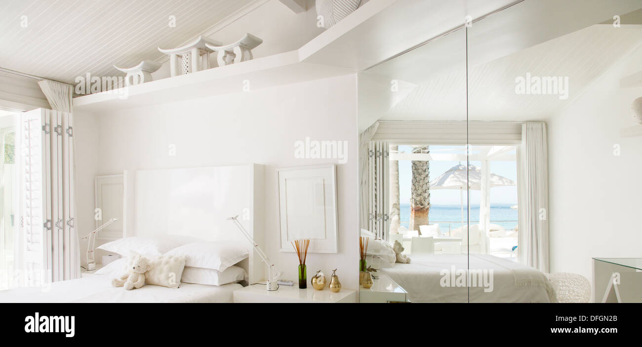 Reflexion von Strand und Meer im Spiegel der weiße Schlafzimmer Stockfoto