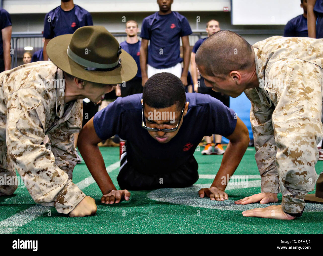 U.S. Marine Corps Drill Instruktoren motivieren ein Rekrut von Marine Corps Recruiting Station Baltimore bei körperlichem Training Tests an der US Naval Academy 11. Mai 2013 in in Annapolis, Maryland. Stockfoto