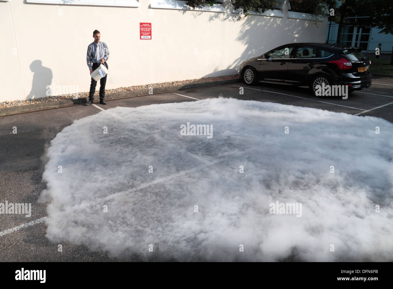 Eine Wolke aus Wasserdampf produziert von Gießen flüssigen Stickstoff (LN2) über einen asphaltierten Parkplatz. Stockfoto