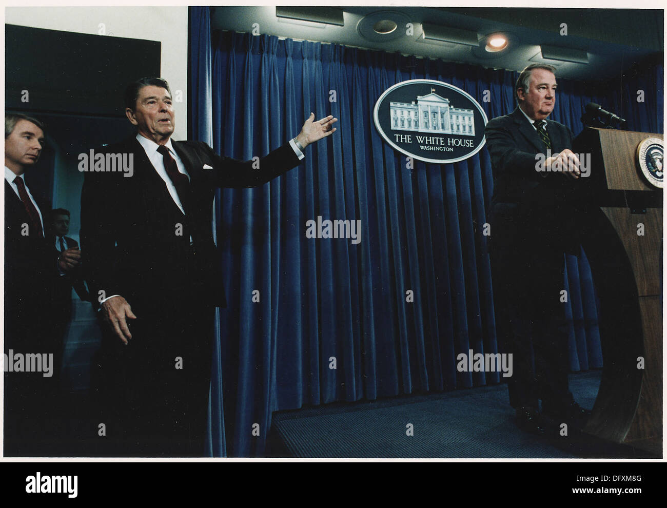 Ein Foto von Präsident Ronald Reagan, der während einer Pressekonferenz des Weißen Hauses über die Iran-Contra-Affäre im Jahr 1985 auf Ed Meese zugeht. Stockfoto