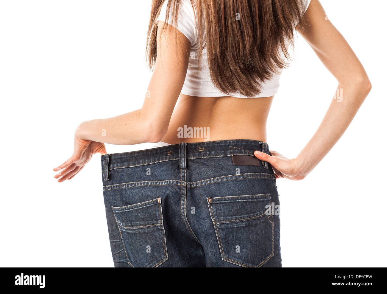 Frau von hinten zeigen, wie viel Gewicht verlor sie, isoliert auf weiss Stockfoto