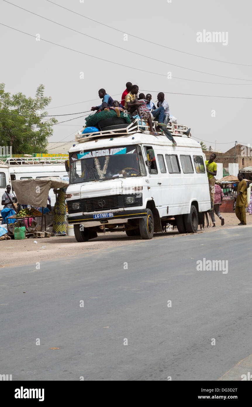Senegal, Touba. Lokaler Verkehr und Verkehrssicherheit. Junge Männer fahren an der Spitze zum Ziel. Stockfoto