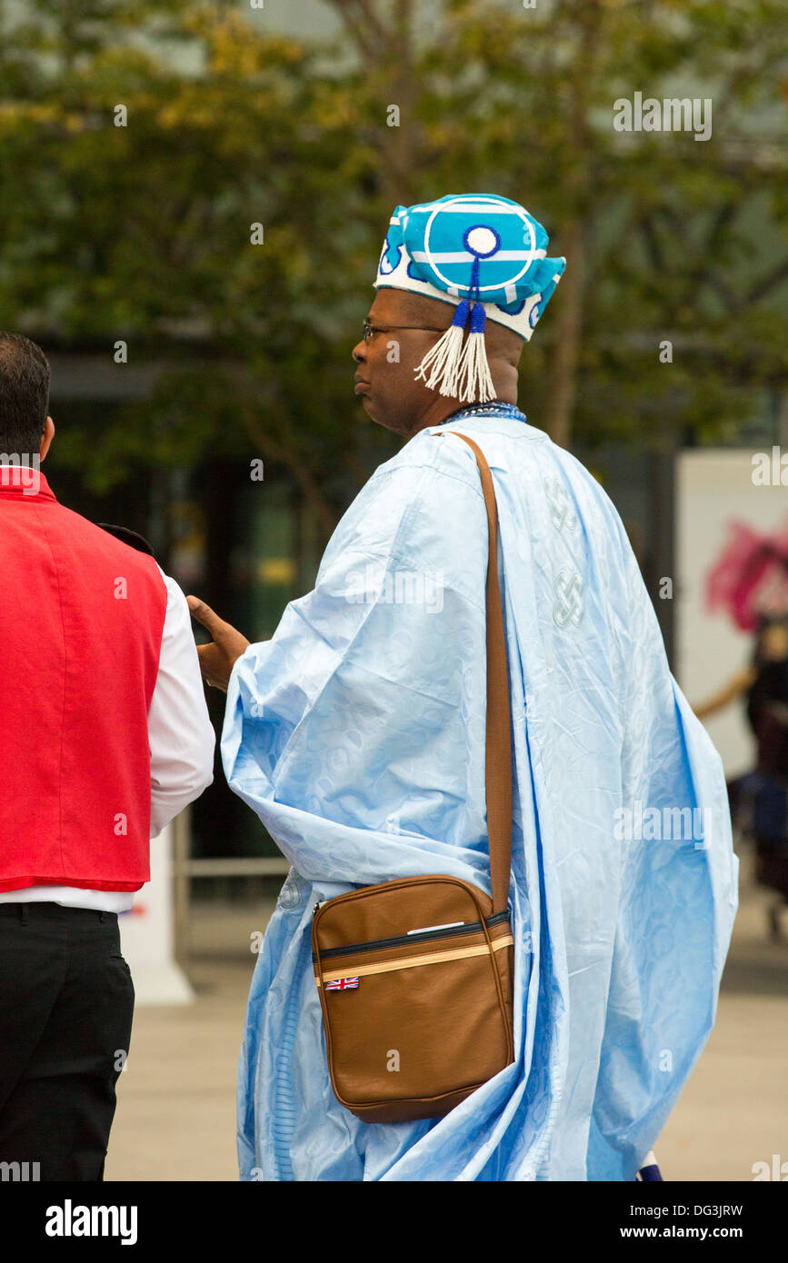 Ein afrikanischer Herr in Reihenstandmotor afrikanischen Kleid am Flughafen Heathrow, London, UK. Stockfoto