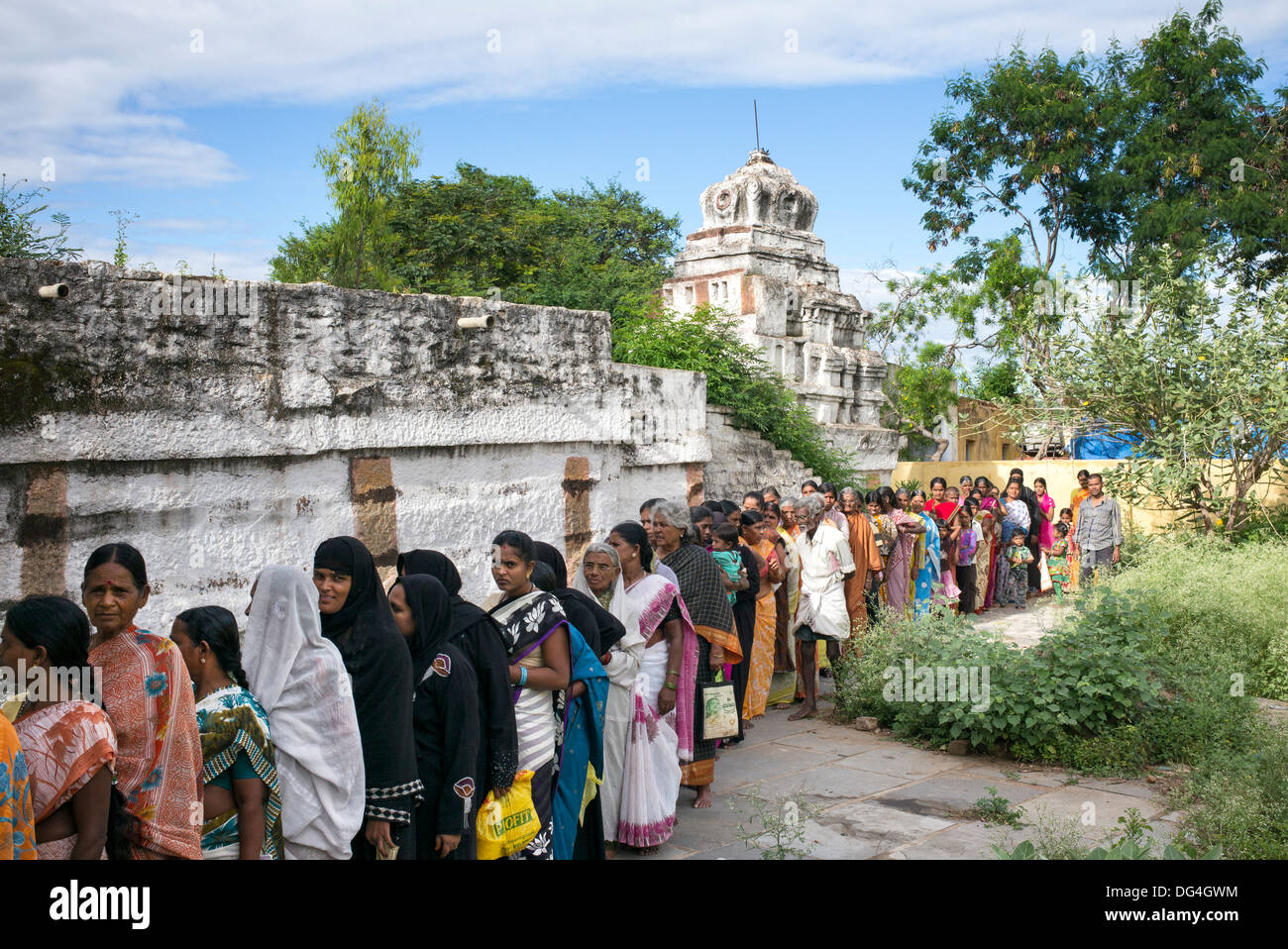 Indische Landfrauen Patienten Schlange in einem Tempel für das Sri Sathya Sai Baba mobile aufsuchende Krankenhaus. Andhra Pradesh, Indien Stockfoto