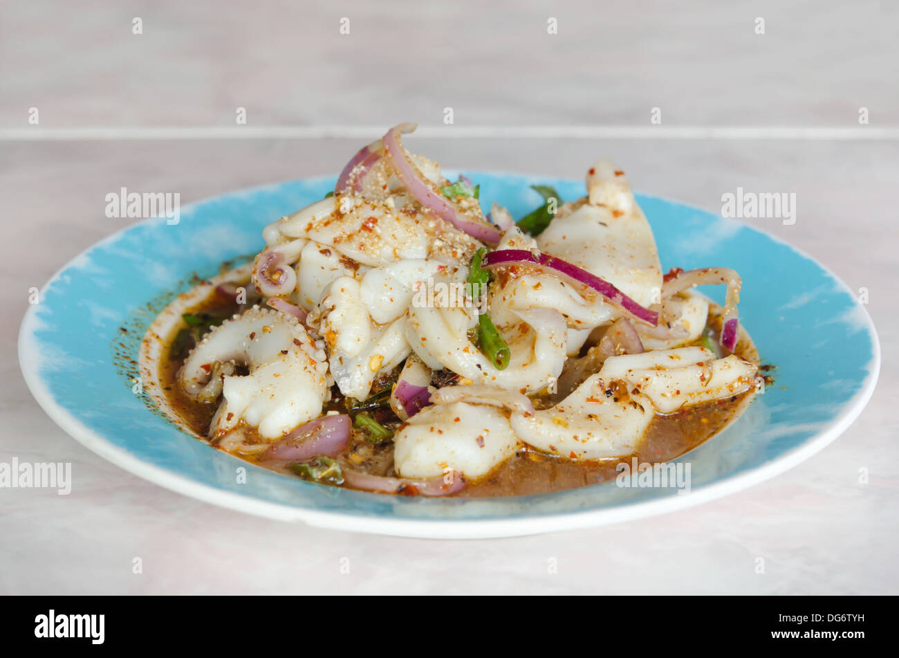 pikante Meeresfrüchtesalat mit Tintenfisch und Chili-Sauce auf Teller Stockfoto