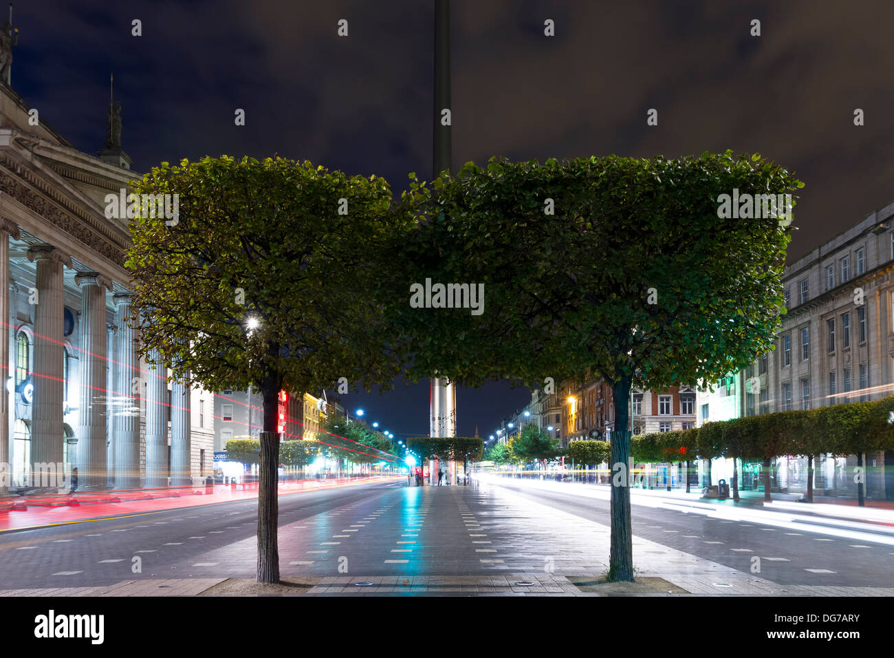 Der Blick auf das Dublin Spire-Monument auf der O' Connell Street in der Abenddämmerung. Durchgangsverkehr Lichtspuren im Hintergrund verlassen. Stockfoto
