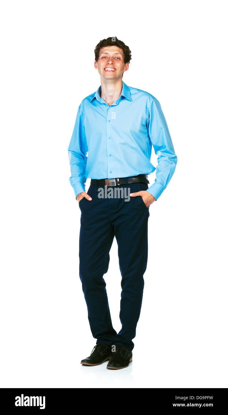 Glückliche junge Geschäftsmann stehend mit den Händen in den Taschen auf weißem Hintergrund Stockfoto