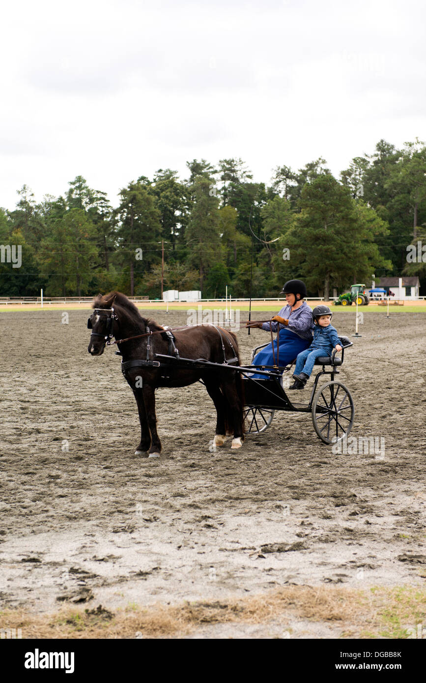 Frau und Kind reiten Pferd gezeichneten Wagen in Pinehurst, North Carolina Stockfoto