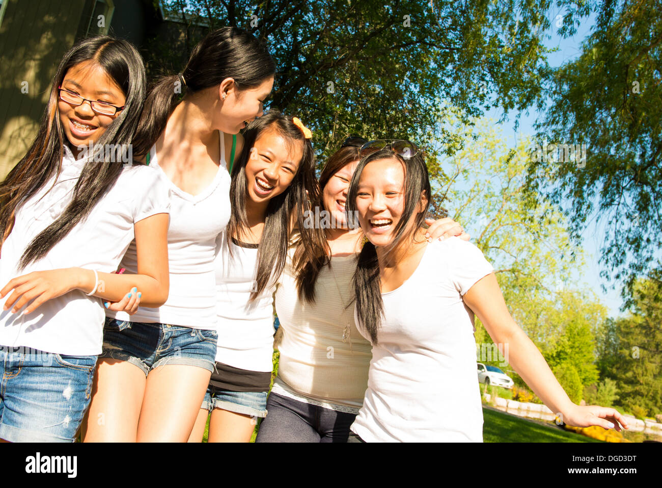 Fünf Mädchen tragen weiße T-shirts, lachen Stockfoto
