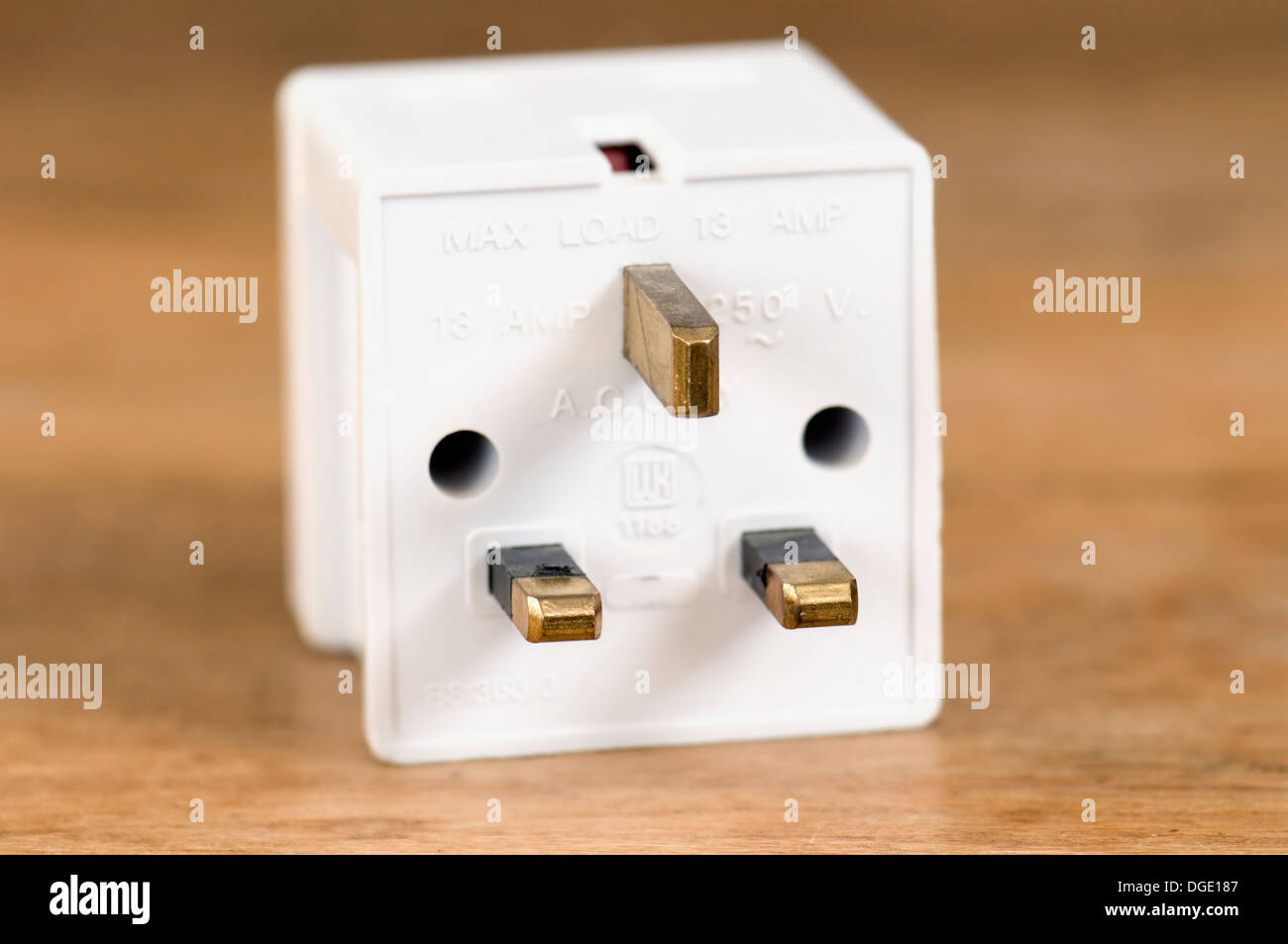 3 stecken Sie Weg Adapter 13 Amp auf hölzernen Tischplatte Stockfoto