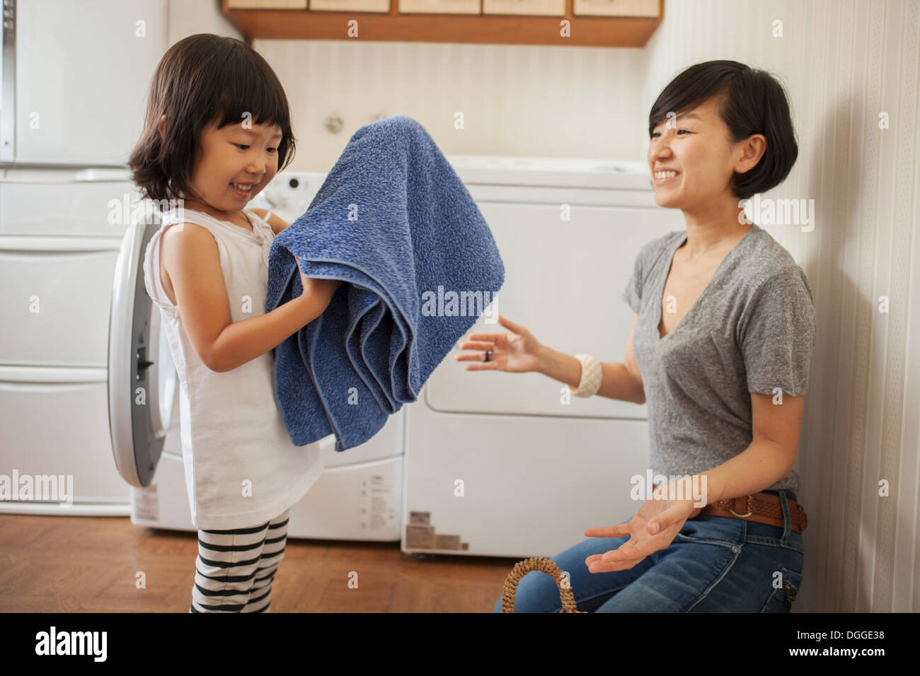 Mutter und Tochter, Mädchen Handtuch Falten Stockfoto