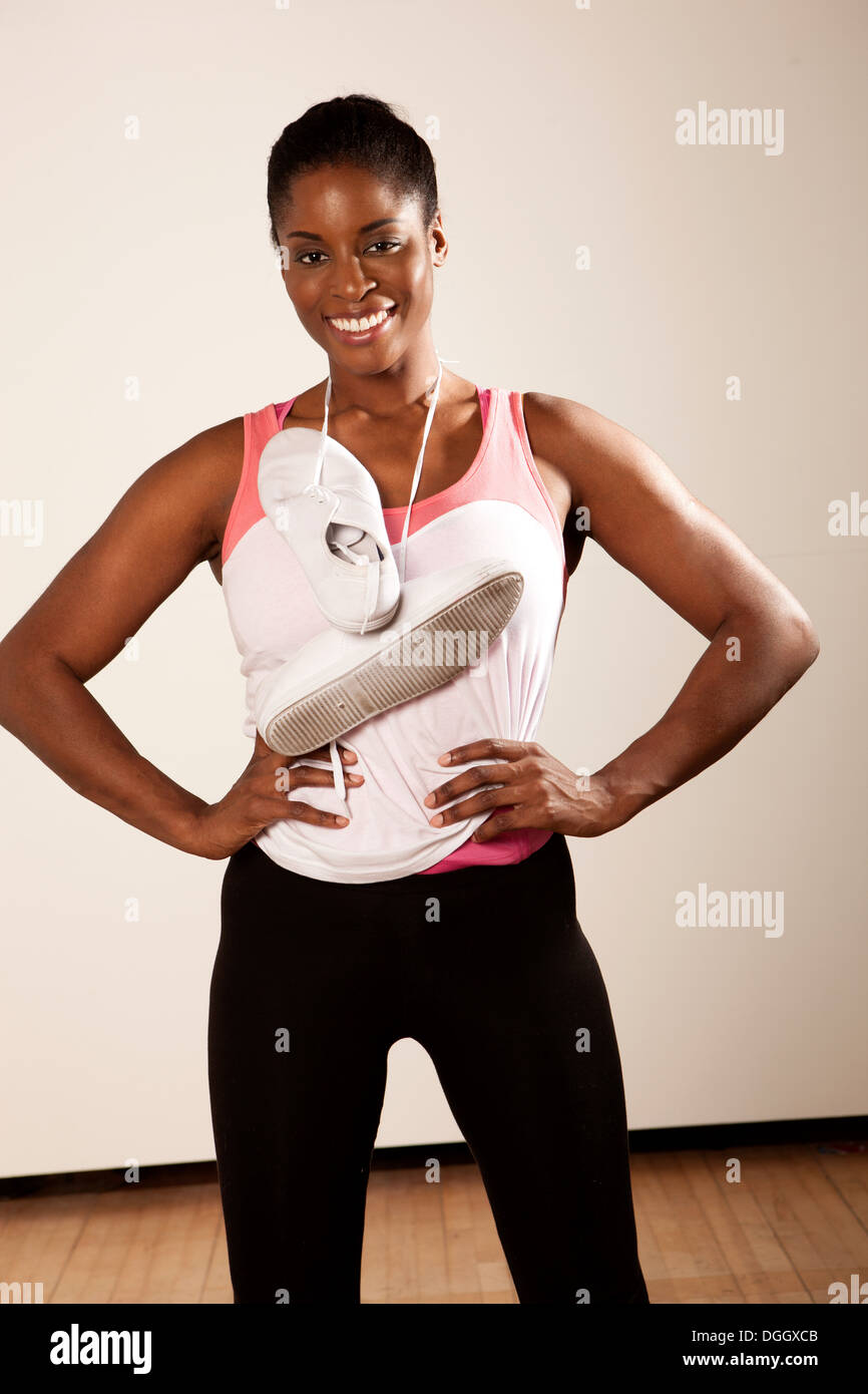 Junge Frau mit Trainer um Hals hängen Stockfoto