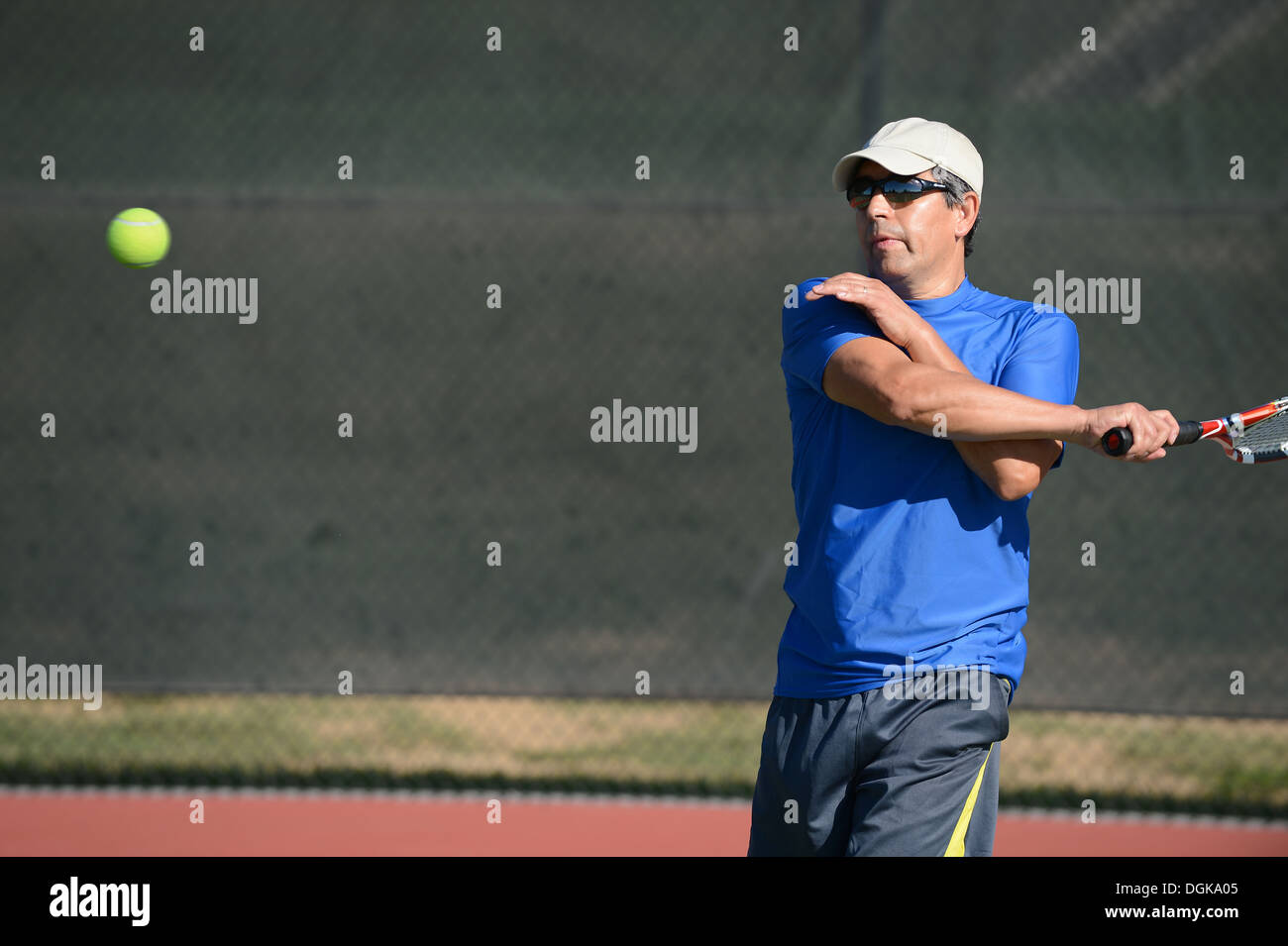 Hispanic Mann spielen Tennis im freien Stockfoto