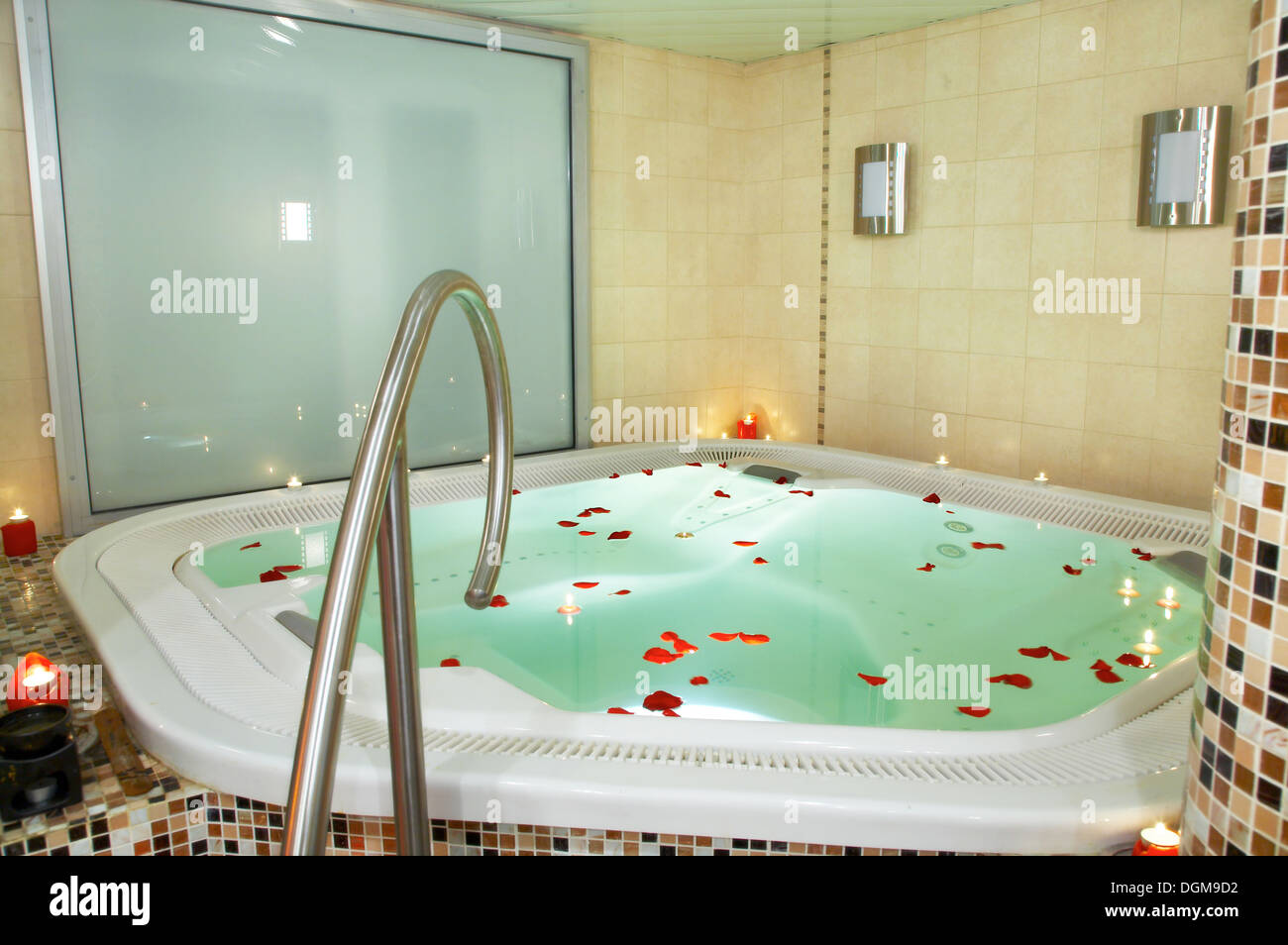 Badewanne mit Whirlpool mit Blütenblättern von Rosen Stockfoto