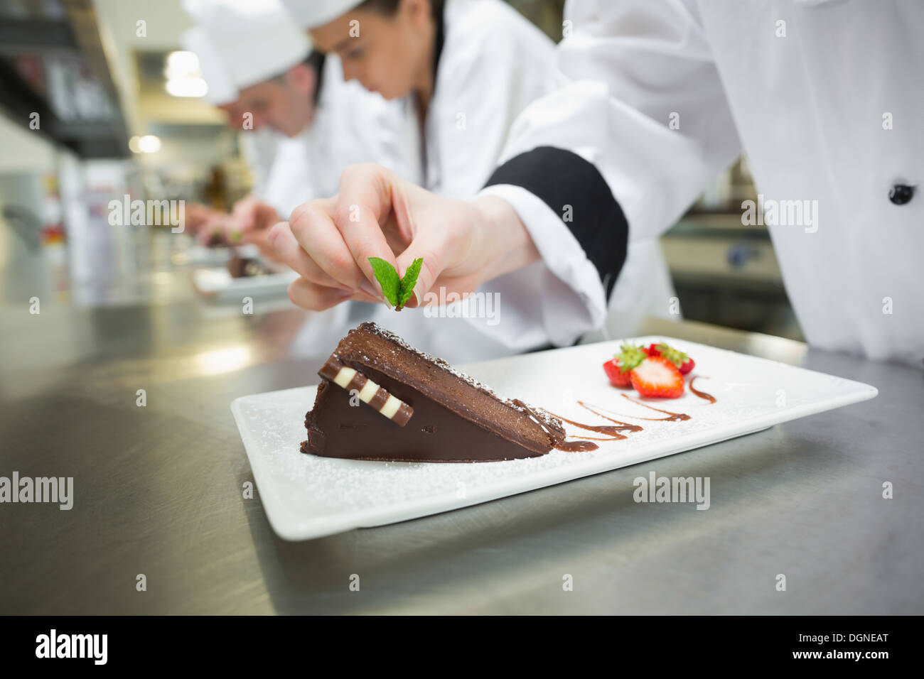 Nahaufnahme von Koch Schokoladenkuchen Minzblatt aufsetzen Stockfoto