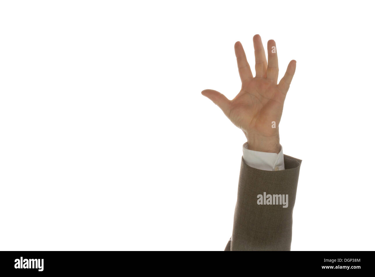 Die Hand eines Mannes in einem Anzug von unten in den Rahmen zu erreichen Stockfoto