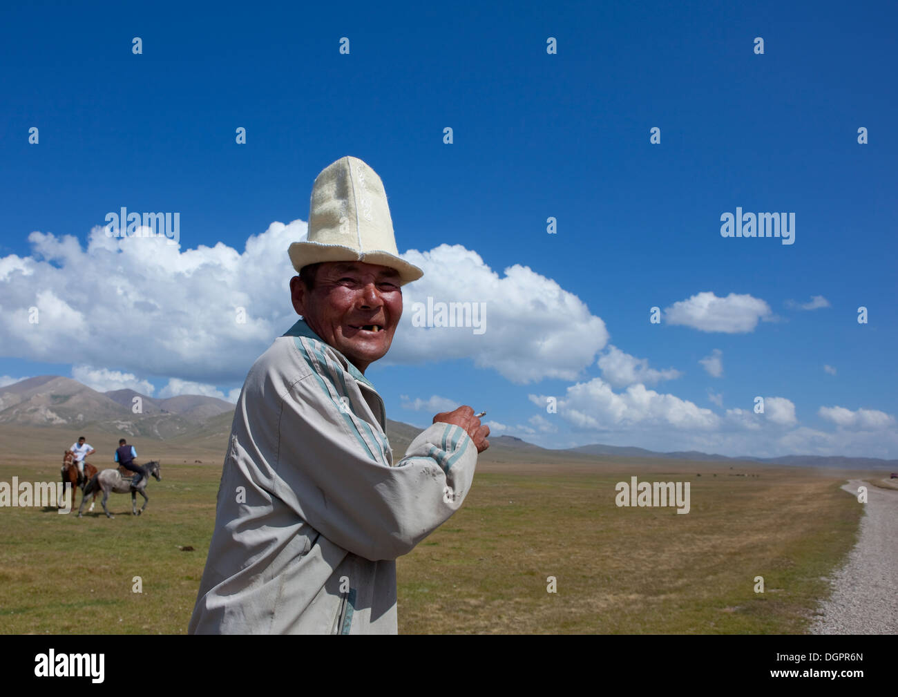 Alter Mann mit Kalpak Hut genießen das Pferdespiel, Lied Kol Seengebiet, Kirgisistan Stockfoto