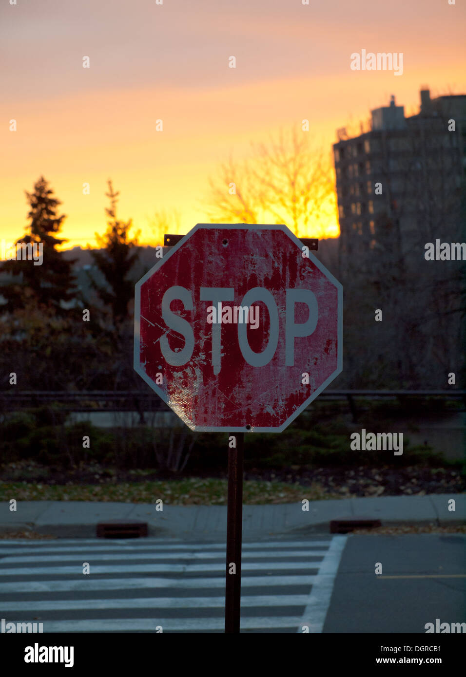 Eine alte, verwitterte Stoppschild bei Sonnenaufgang in Edmonton, Alberta, Kanada. Stockfoto