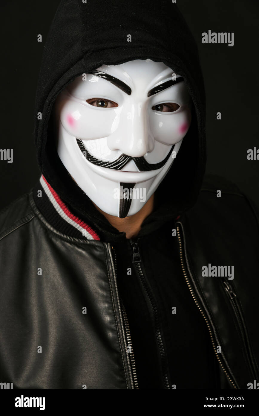 Junger Mann mit einer anonymen Maske mit Kapuze und eine schwarze Lederjacke Stockfoto