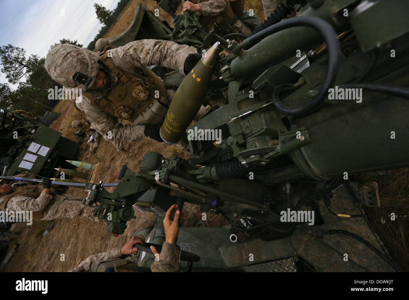 U.S. Marine Corps Lance Cpl. Jacob Carmona, ein Stampfer mit Indien Batterie, 3. Bataillon, 10. Marines lädt eine hochexplosive Runde in der Laden-Tablett mit einer Haubitze M777 während der Operation Rolling Thunder an Bord Fort Bragg, N.C., 18. Oktober 2013. 10. marine Stockfoto