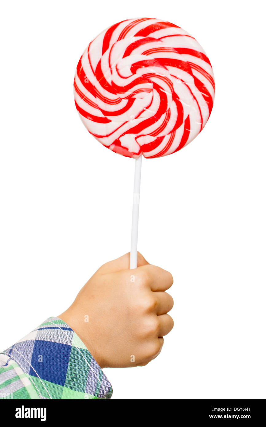 Ein Kind an der Hand hält einen großen weißen und roten Lutscher. Isoliert auf weiss. Stockfoto
