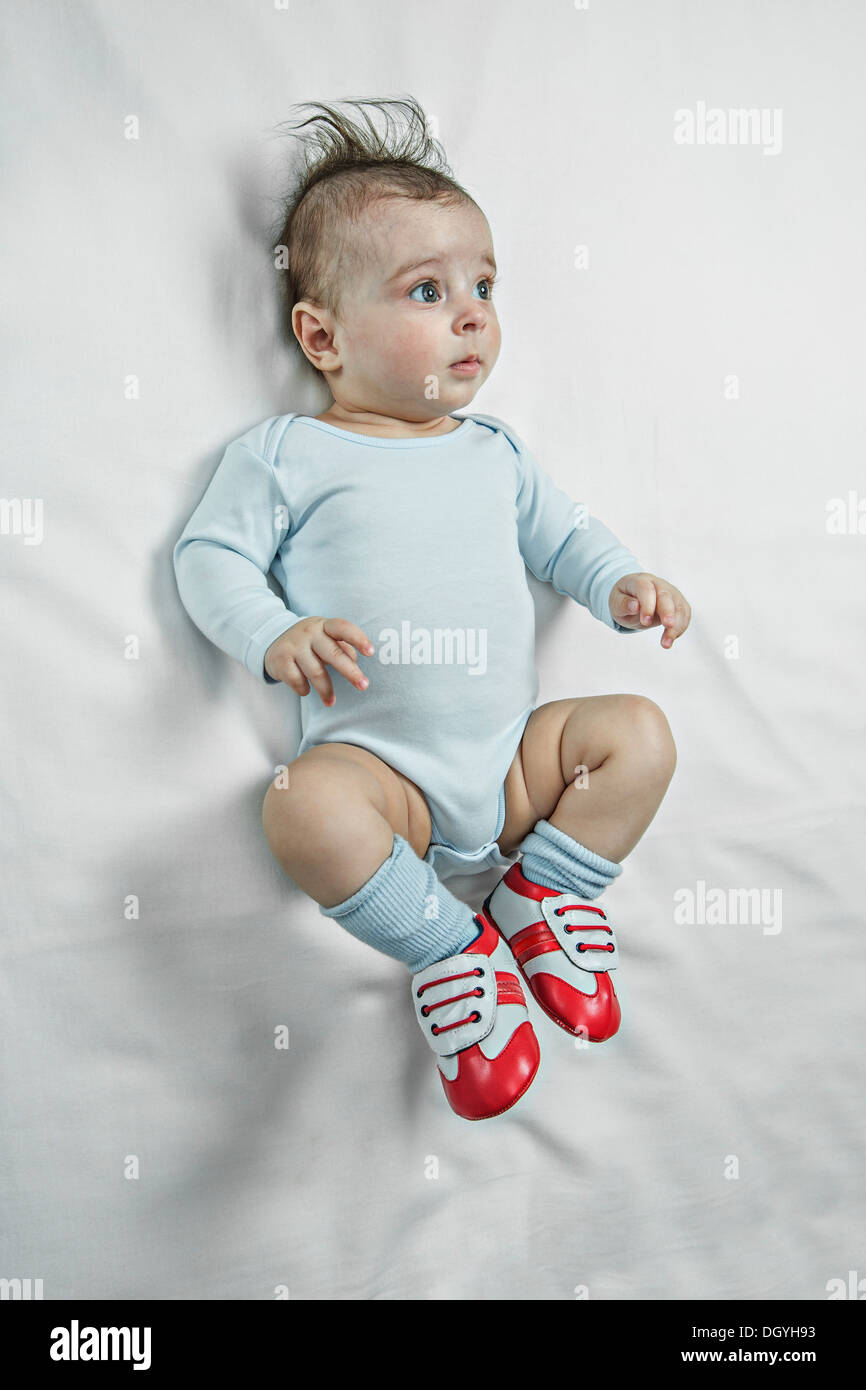 Ein Baby Boy, Baby-Fußball-Schuhe tragen und suchen besinnliche Stockfoto