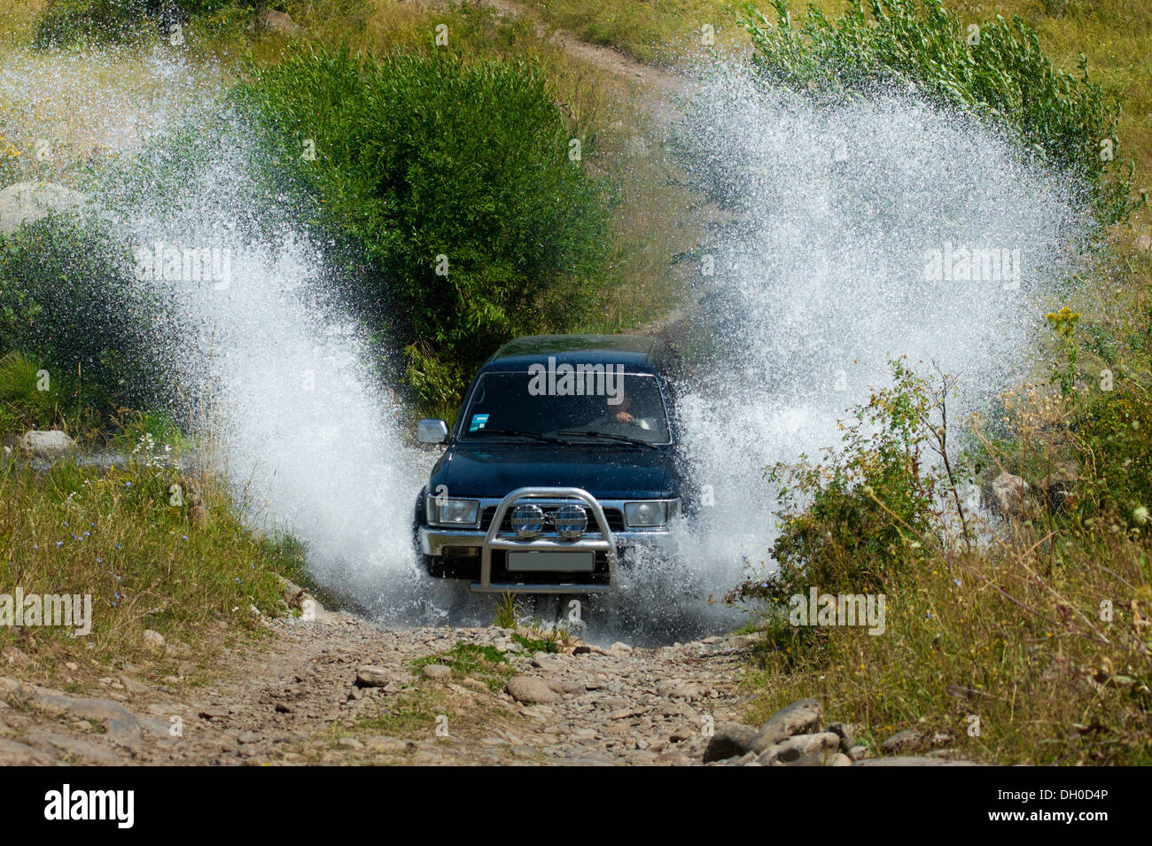 Geländewagen, Überquerung des Flusses mit hoher Geschwindigkeit und reiben das Wasser Stockfoto