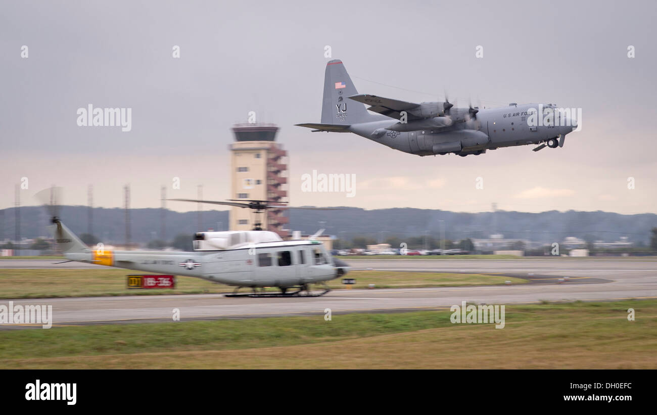 Ein c-130 Hercules zieht vorbei an einem UH-1 Huey während einer Mission große Formation auf Yokota Air Base, Japan, 22. Oktober 2013. Während dieser Mission startete Team Yokota jedes Flugzeug derzeit Yokota stationiert. Stockfoto