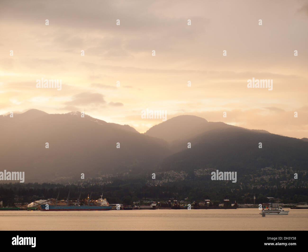 Markante Sonnenuntergang über Vancouver Harbour, North Vancouver und Grouse Mountain gesehen von der Innenstadt von Vancouver, BC, Kanada. Stockfoto