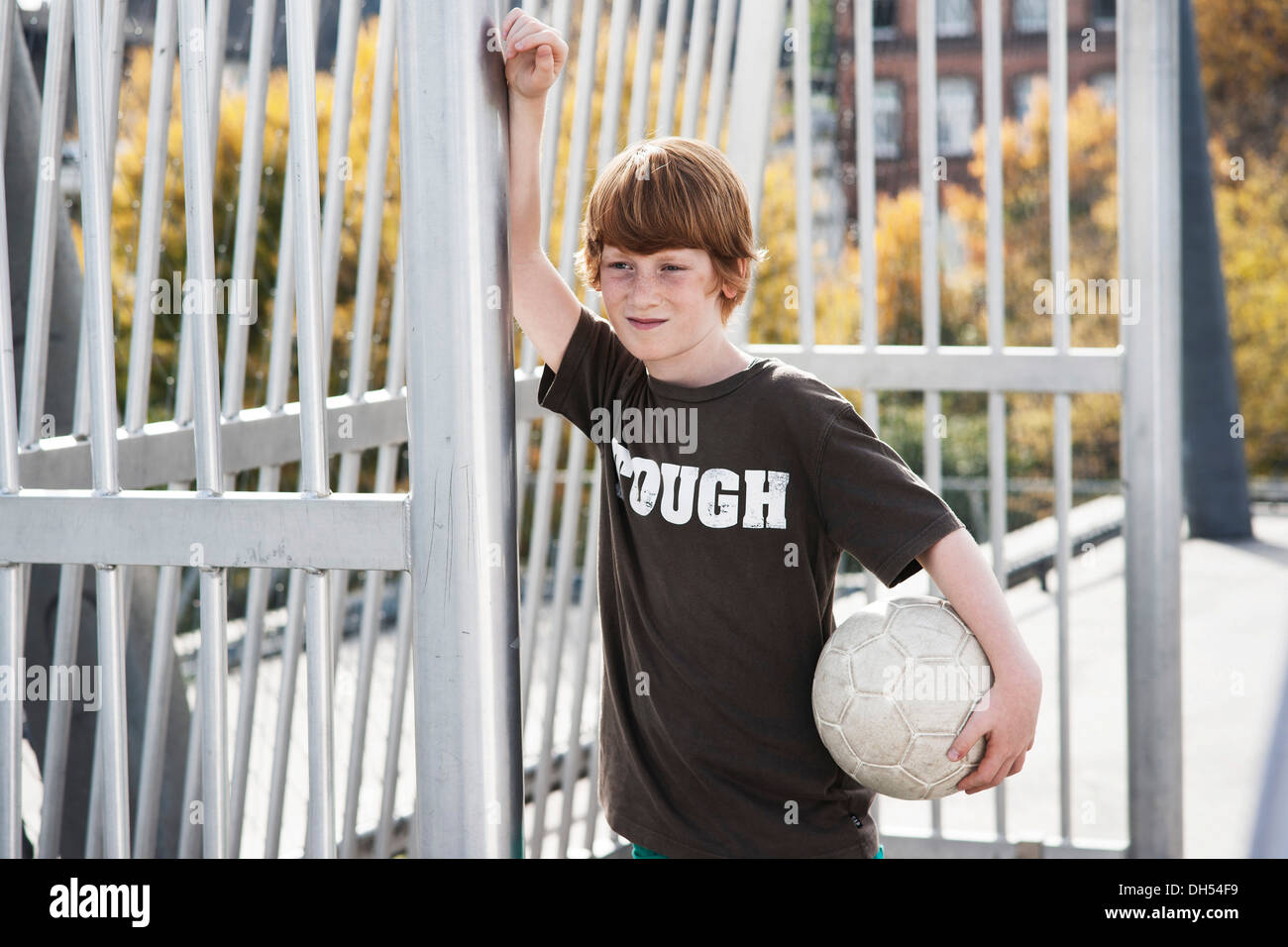 Coole junge hält einen Fußball Stockfoto