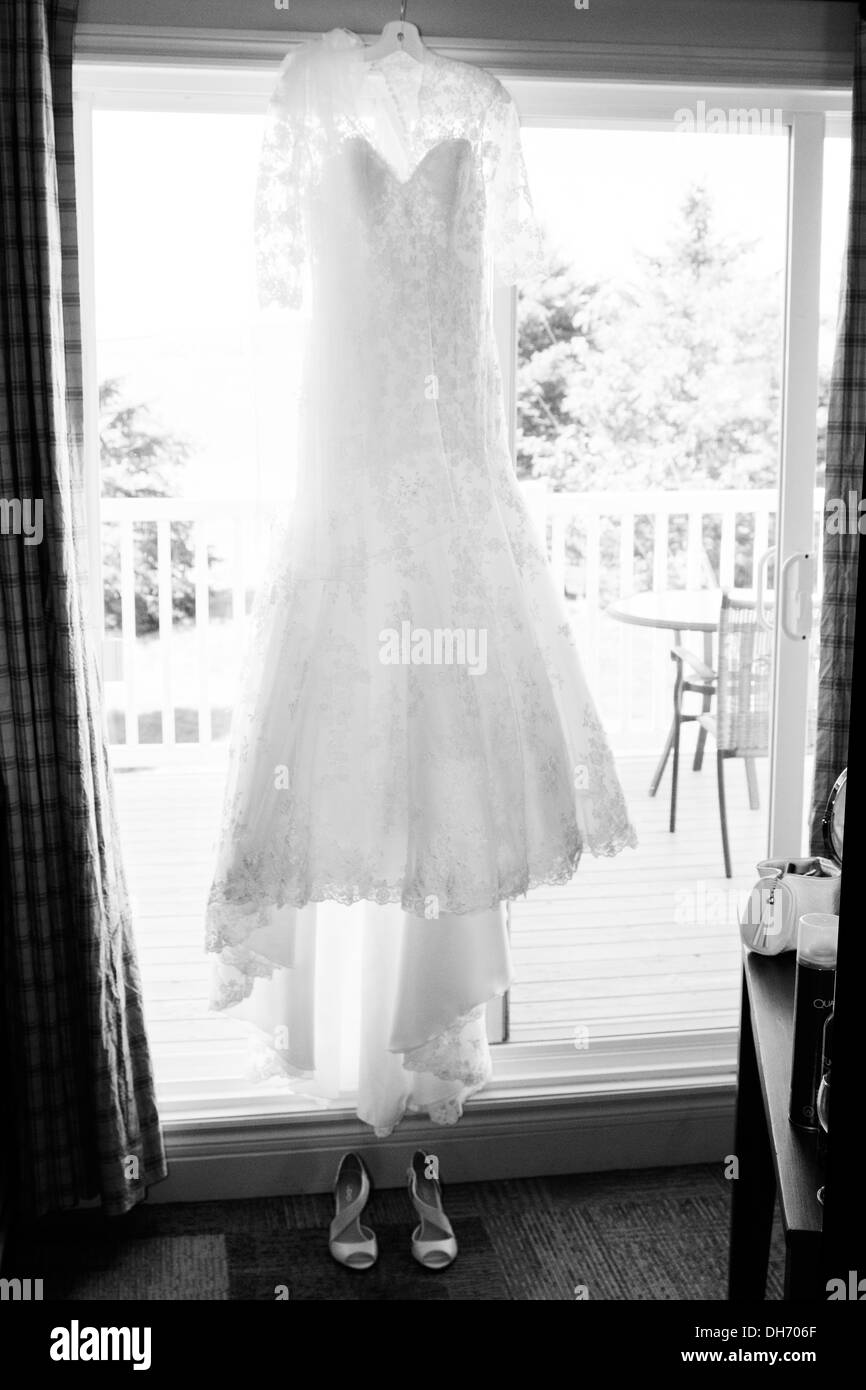 Schuss von Hochzeitskleid und Schuhe im Fenster Stockfoto
