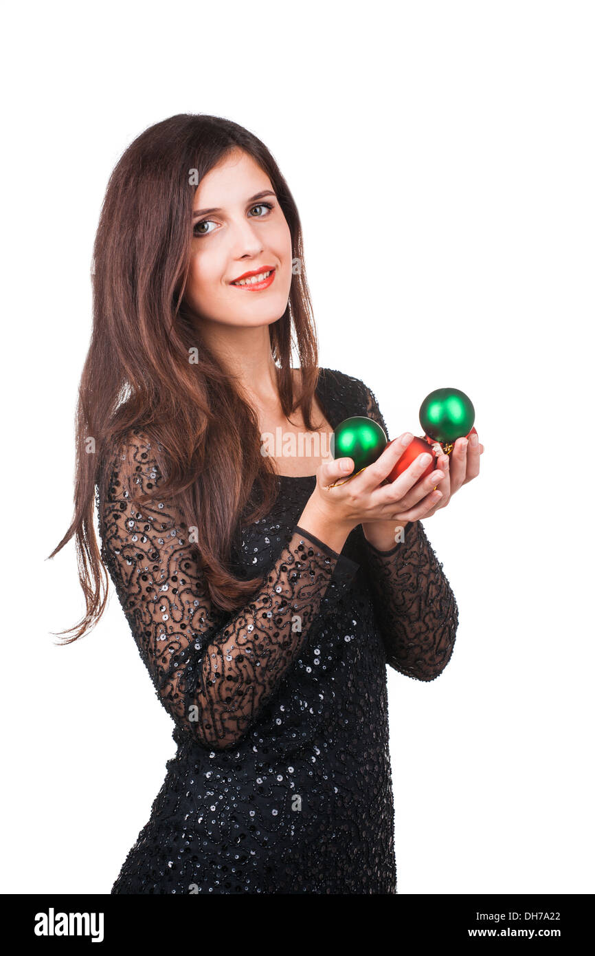 Junges Mädchen mit Weihnachtskugeln in Händen Stockfoto