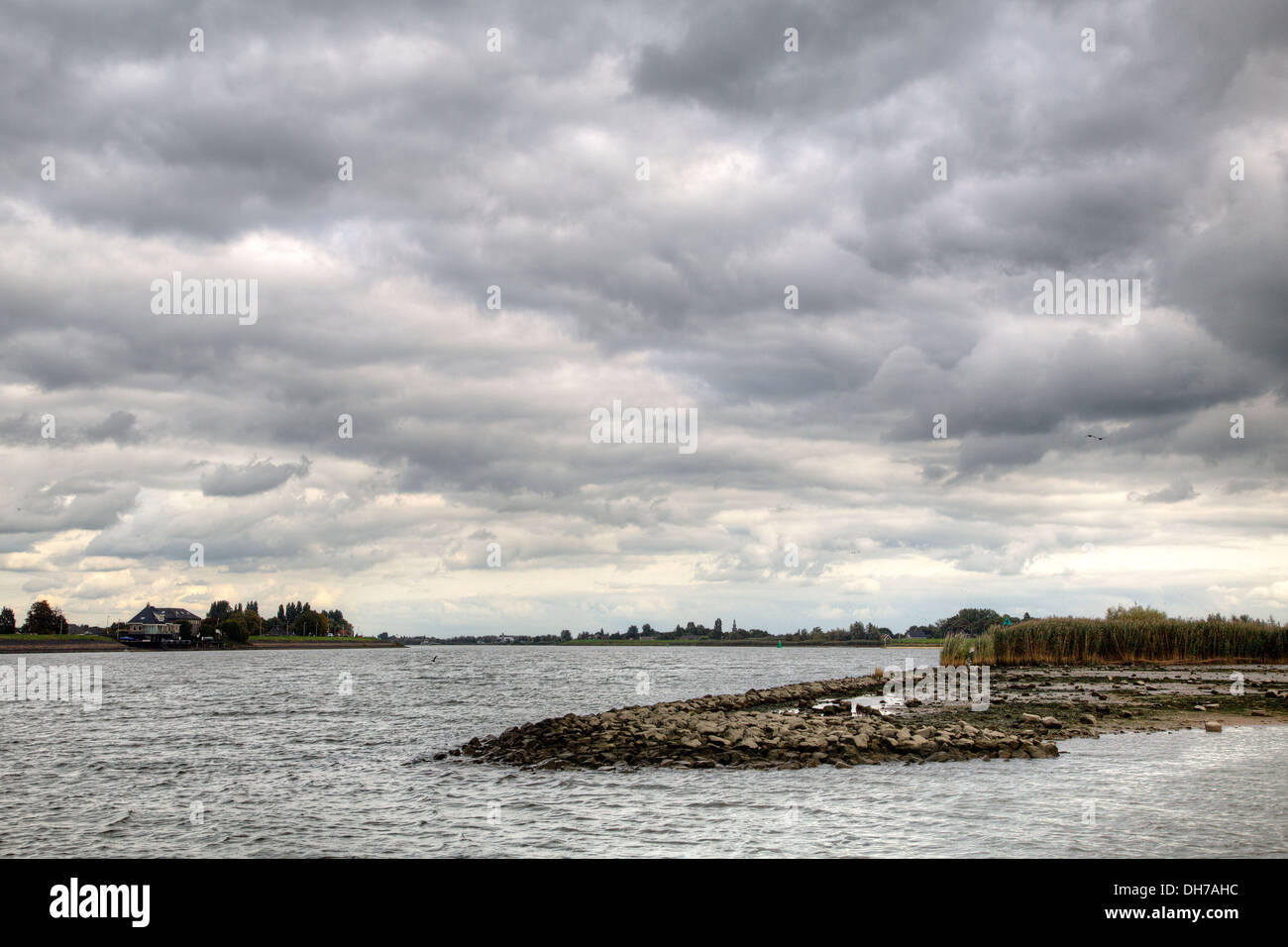 Niederländische Fluss Lek unter dunklen Wolken, Nieuw-Lekkerland, Südholland, Niederlande Stockfoto
