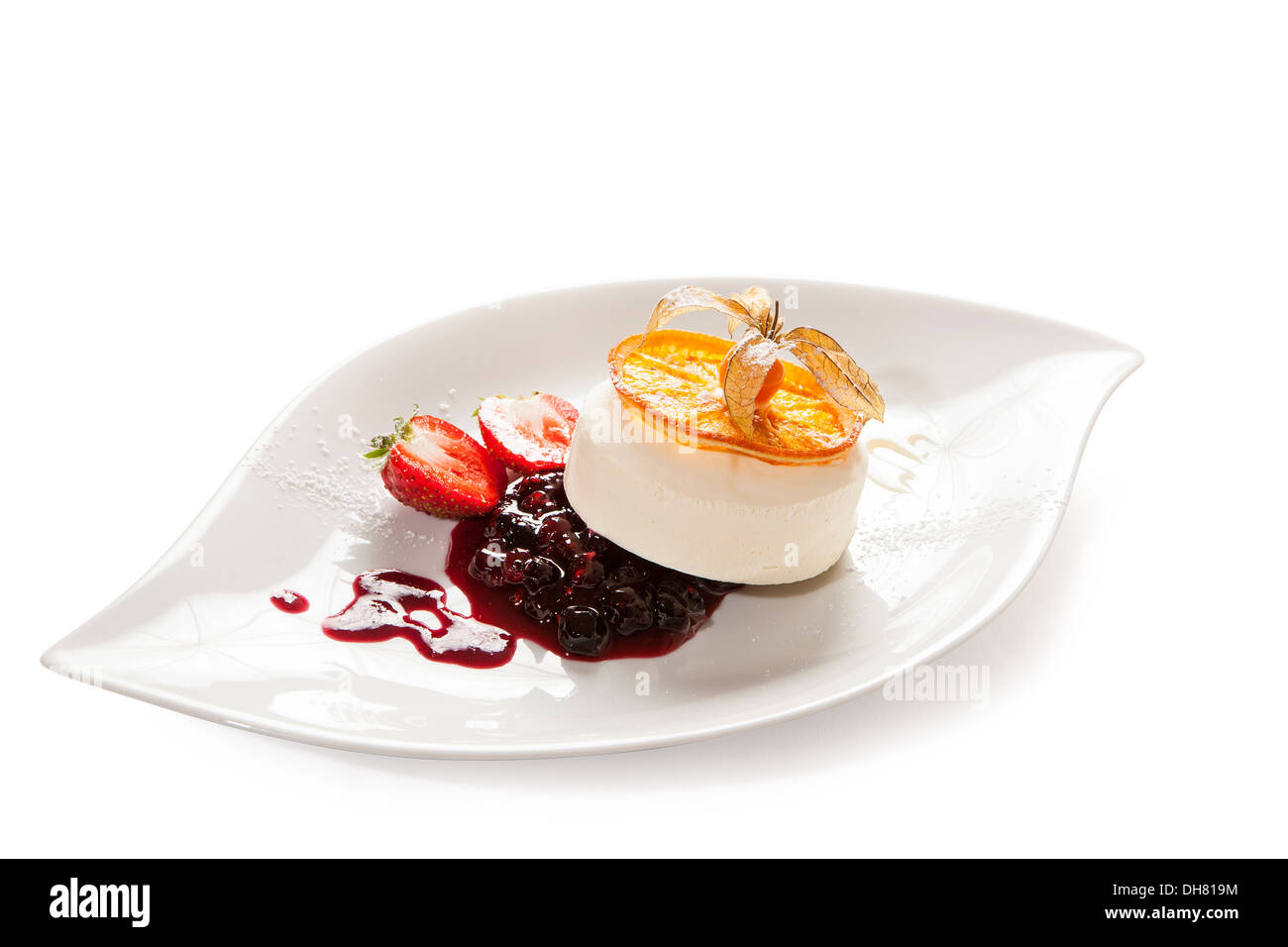 Vanilleeis mit Heidelbeer-Kompott serviert auf einem Teller mit Erdbeeren und karamellisierten Orangenscheibe Stockfoto