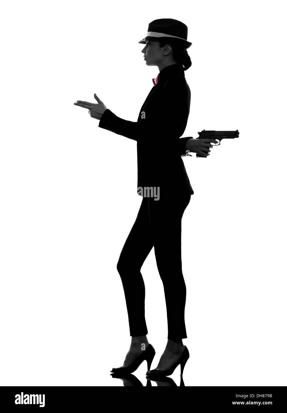 eine stilvolle Frau im Anzug mit Pistole in der Silhouette auf weißem Hintergrund Stockfoto