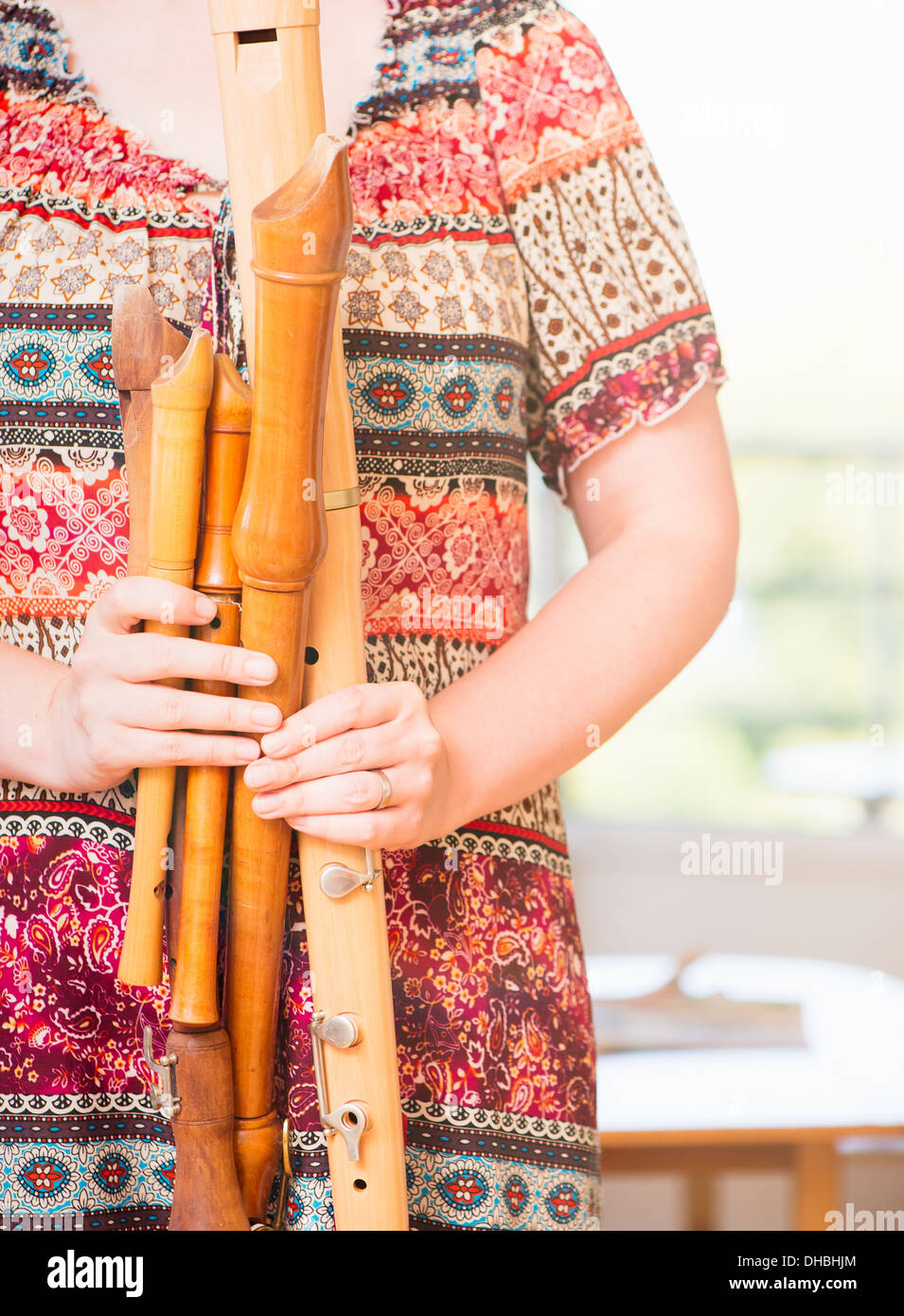 Nahaufnahme von Frau hält eine Vielzahl von Holzflöten Stockfoto