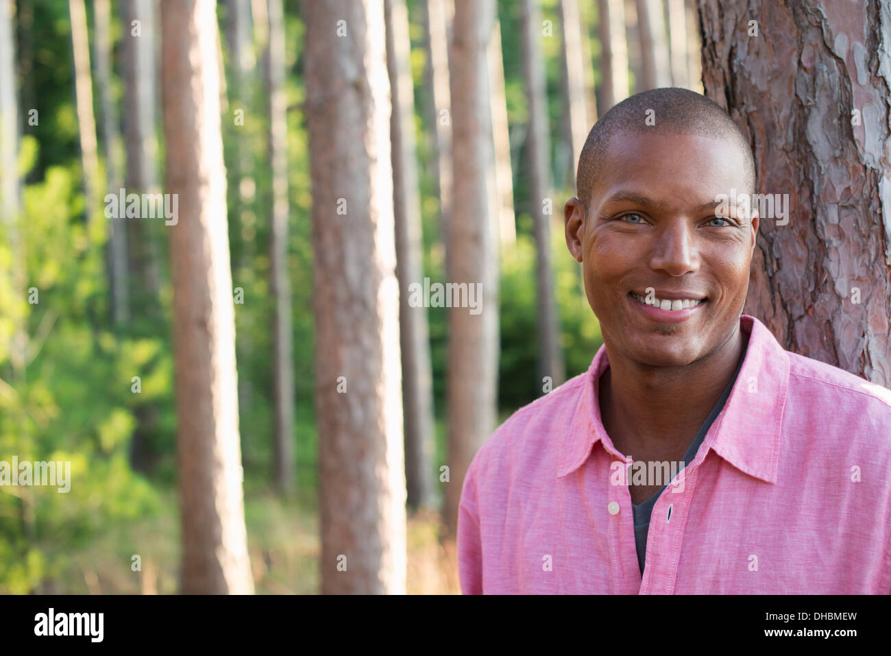 Bäume am Ufer eines Sees. Ein Mann in die Kamera Lächeln. Stockfoto