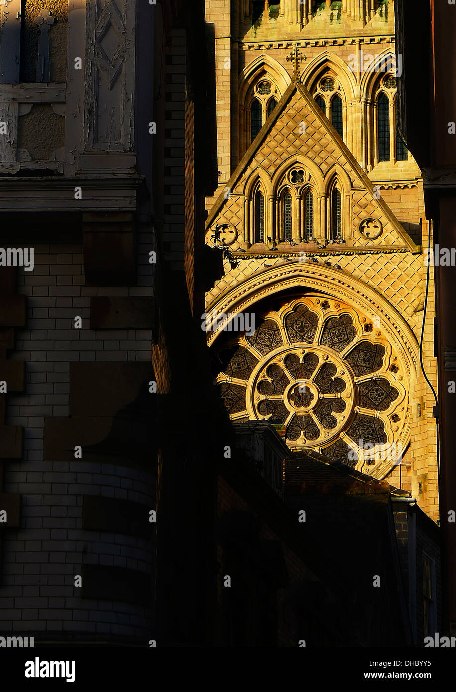 Goldene Stunde Sonnenlicht auf ein Fenster des Truro Cathedral, gesehen durch shopping Gasse Straßenniveau Stockfoto