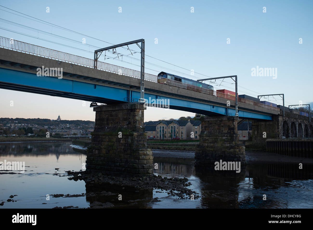 Güterzug auf der Eisenbahnbrücke überquert den Fluss Lune in Lancaster UK Stockfoto