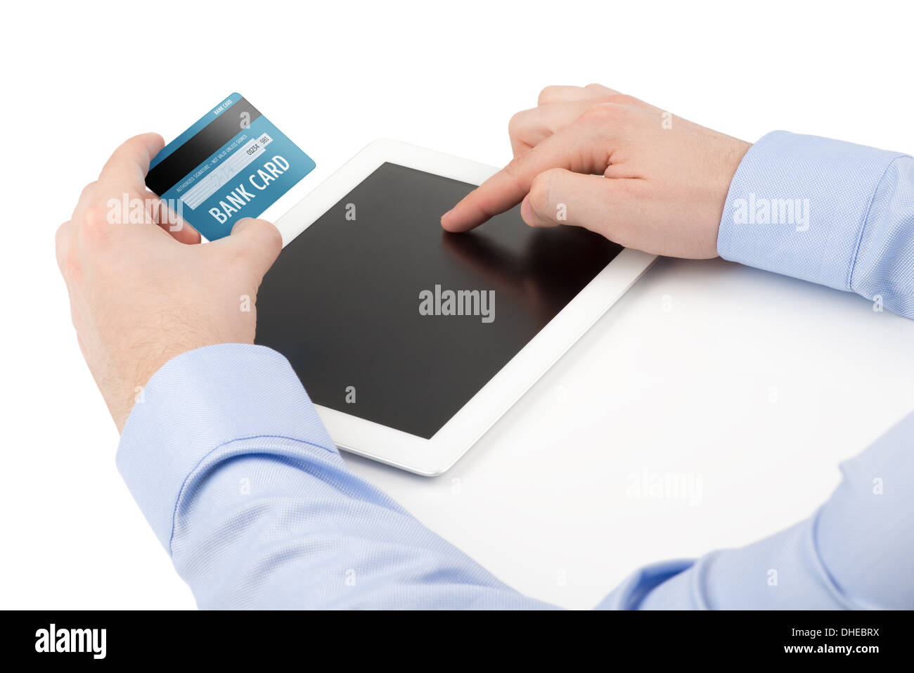 Hand des Mannes mit einer Kreditkarte über einen Tabletcomputer und die andere Hand berühren des Bildschirms auf einem weißen Hintergrund. Stockfoto