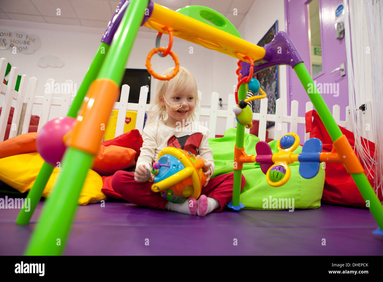 Ein junges Mädchen genießt das Spielzimmer in einem Krankenhaus UK Stockfoto
