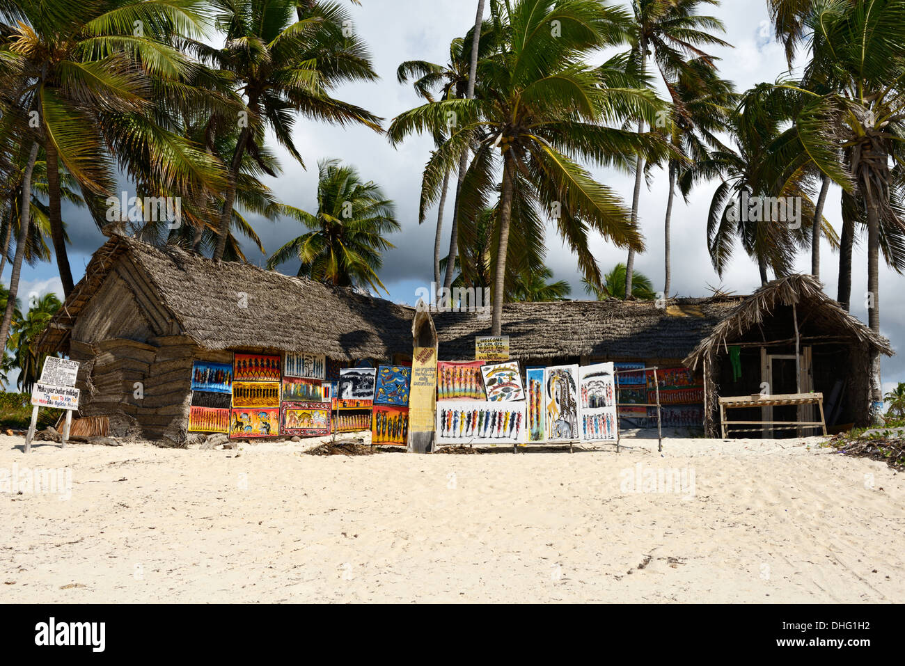 Afrikanische Kunst für den Verkauf von traditionellen Makuti Hütten am Strand Bwejuu, Zanzibar, Tansania, Ostafrika Stockfoto