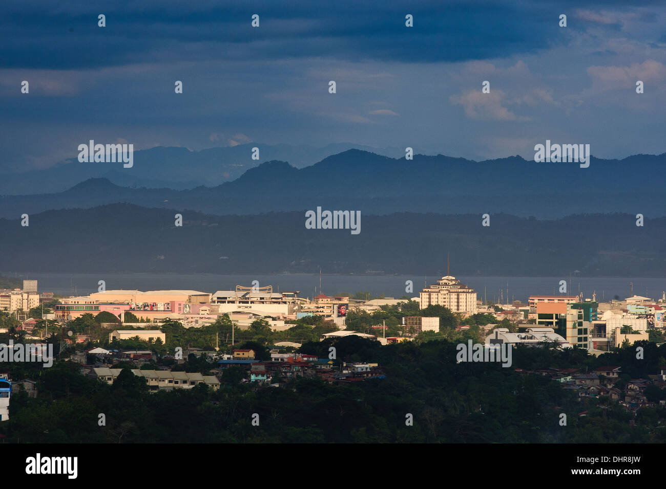 Schichten der Gebäude der Stadt werden durch die Sonne über Davao hervorgehoben. Stockfoto