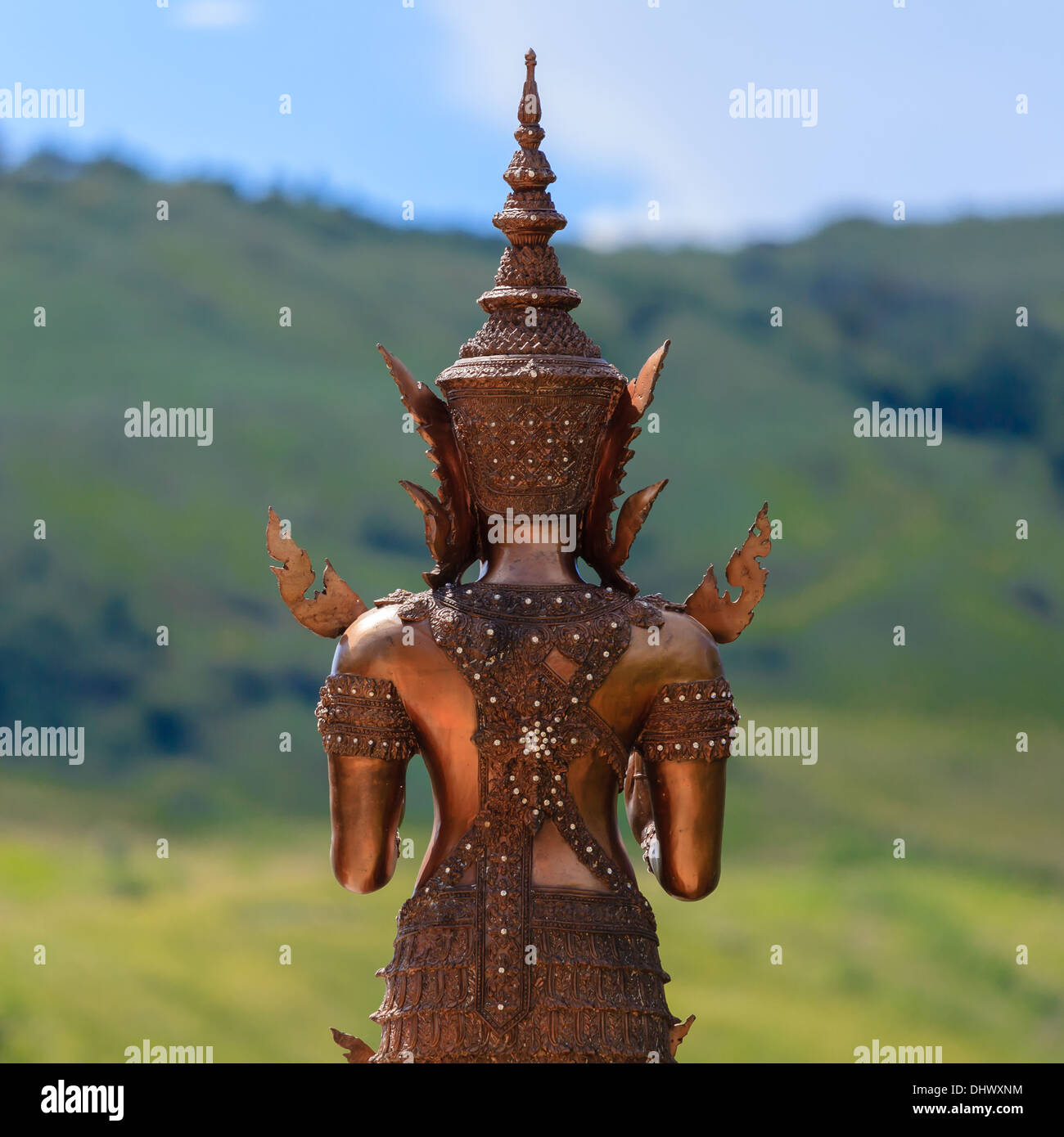 Rückseite des Metall Buddha-Statue mit dem Hügel im Hintergrund Stockfoto