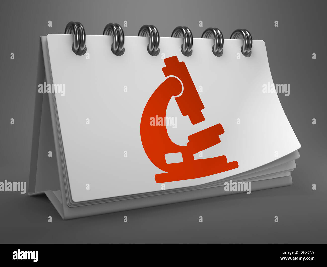 Desktop-Kalender mit Mikroskop-Symbol. Stockfoto