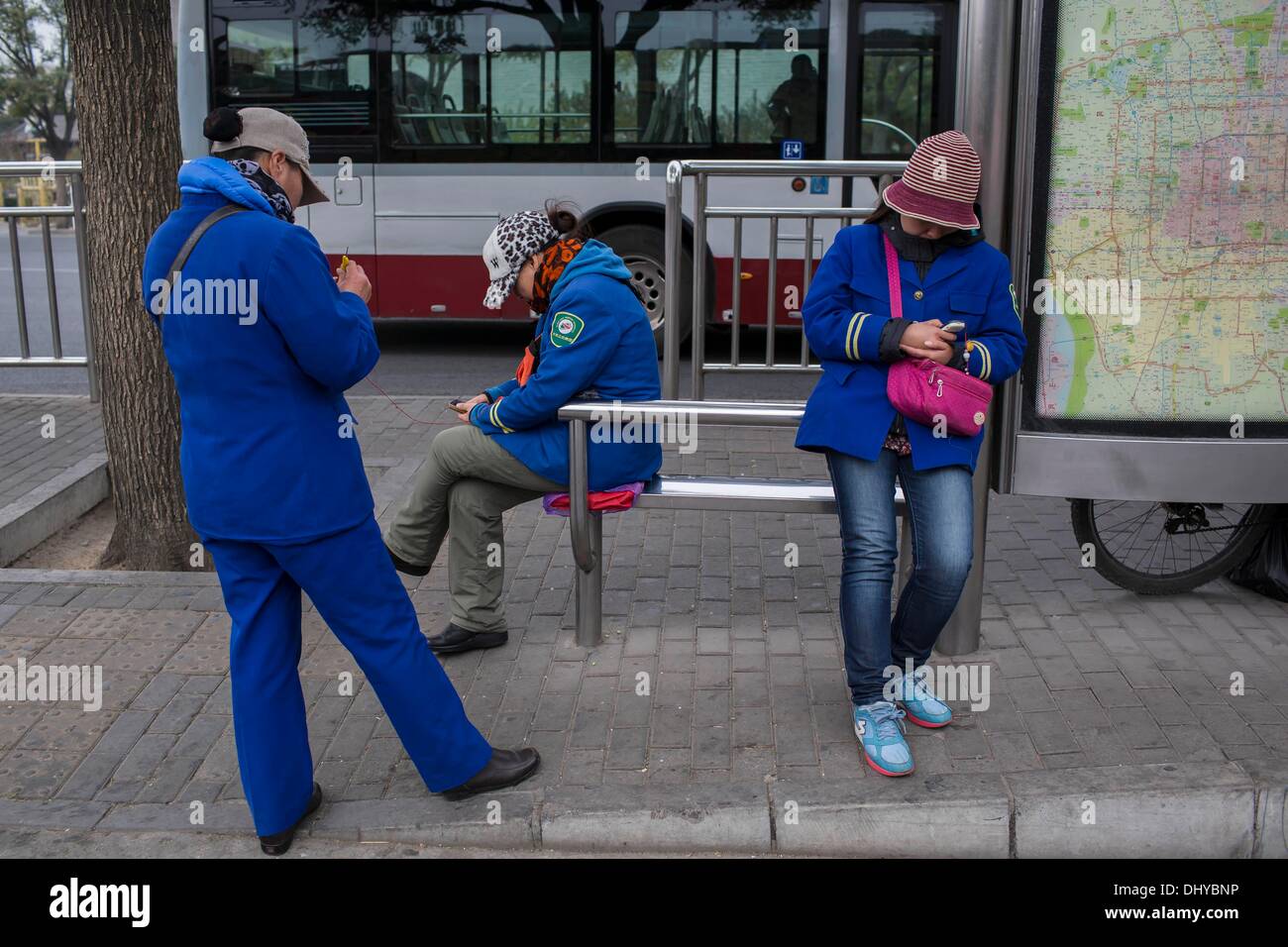 Peking, China. 9. November 2013. Drei Dirigenten versammeln sich an einer Bushaltestelle, Qianmen Street, Beijing, China. © Jiwei Han/ZUMA Wire/ZUMAPRESS.com/Alamy Live-Nachrichten Stockfoto