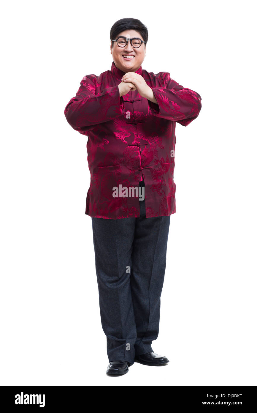 Junger Mann in Tang Anzug Gruß für Chinese New Year Stockfoto