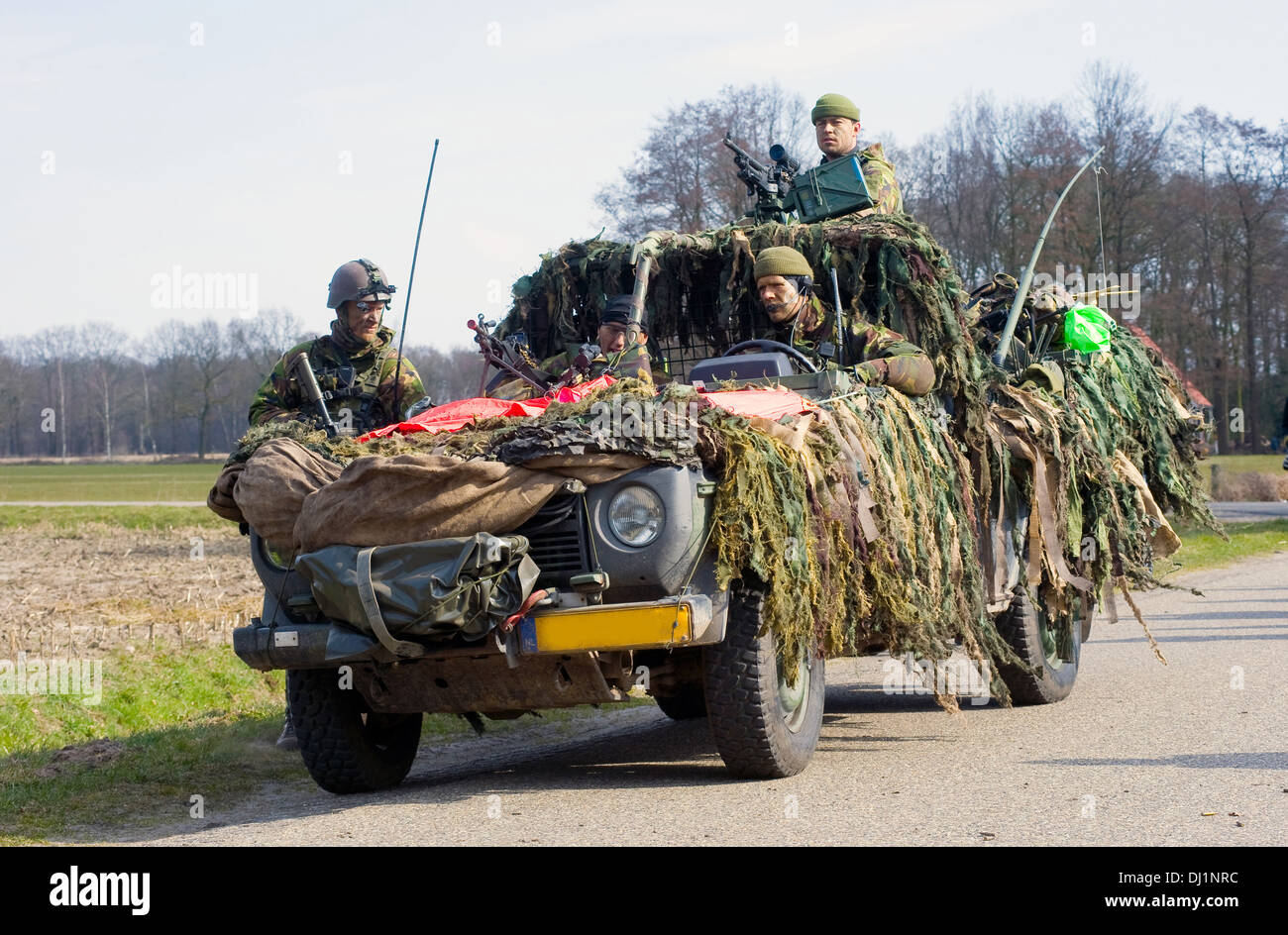 Vier getarnte Soldaten warten auf Anweisungen während eines Trainings der Special Forces der niederländischen Armee an einem kalten Tag Stockfoto