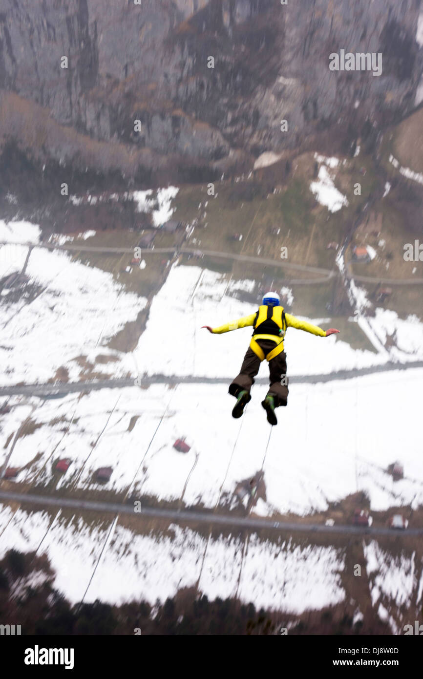 Base-Jumper wird von einer Klippe hinunter in das tiefe Tal beendet. Dabei hält er seine Arme nach hinten, nach vorne zu verfolgen. Stockfoto