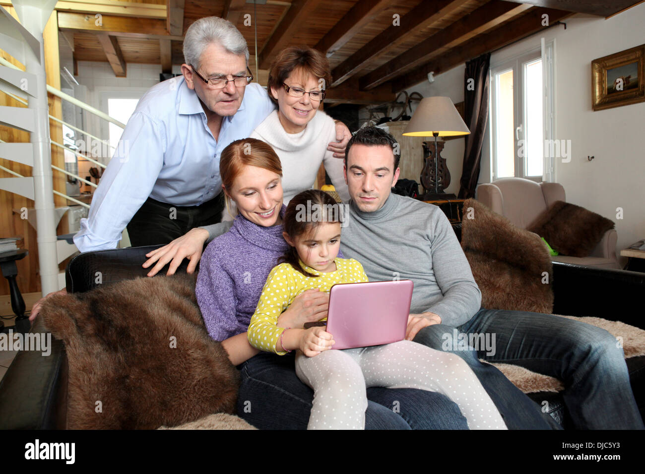 Ganze Familie um einen laptop Stockfoto